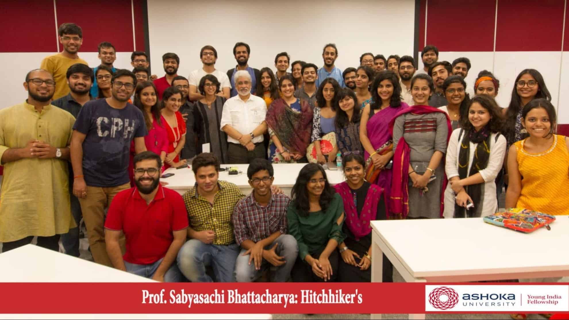 A group of students and a professor pose together in a classroom at Ashoka University.