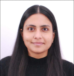 Woman with long black hair, wearing a black sweater, smiling slightly against a white background.