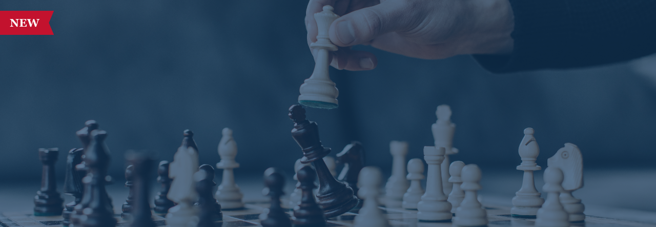 Hand moving a white chess piece during a game, with black and white chess pieces on the board.