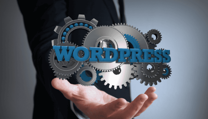 Gears surrounding the word "WordPress" floating above an outstretched hand in a suit.